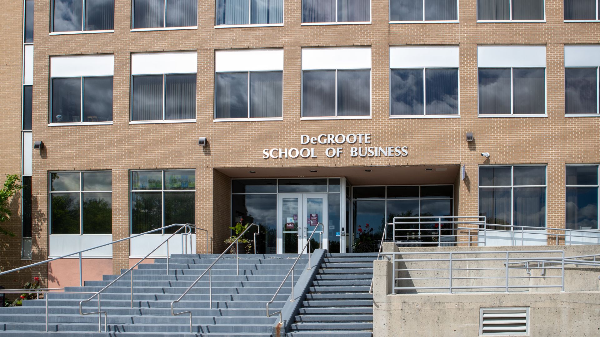 A brick building with the lettering 'DeGroote School of Business' above its entrance doors.