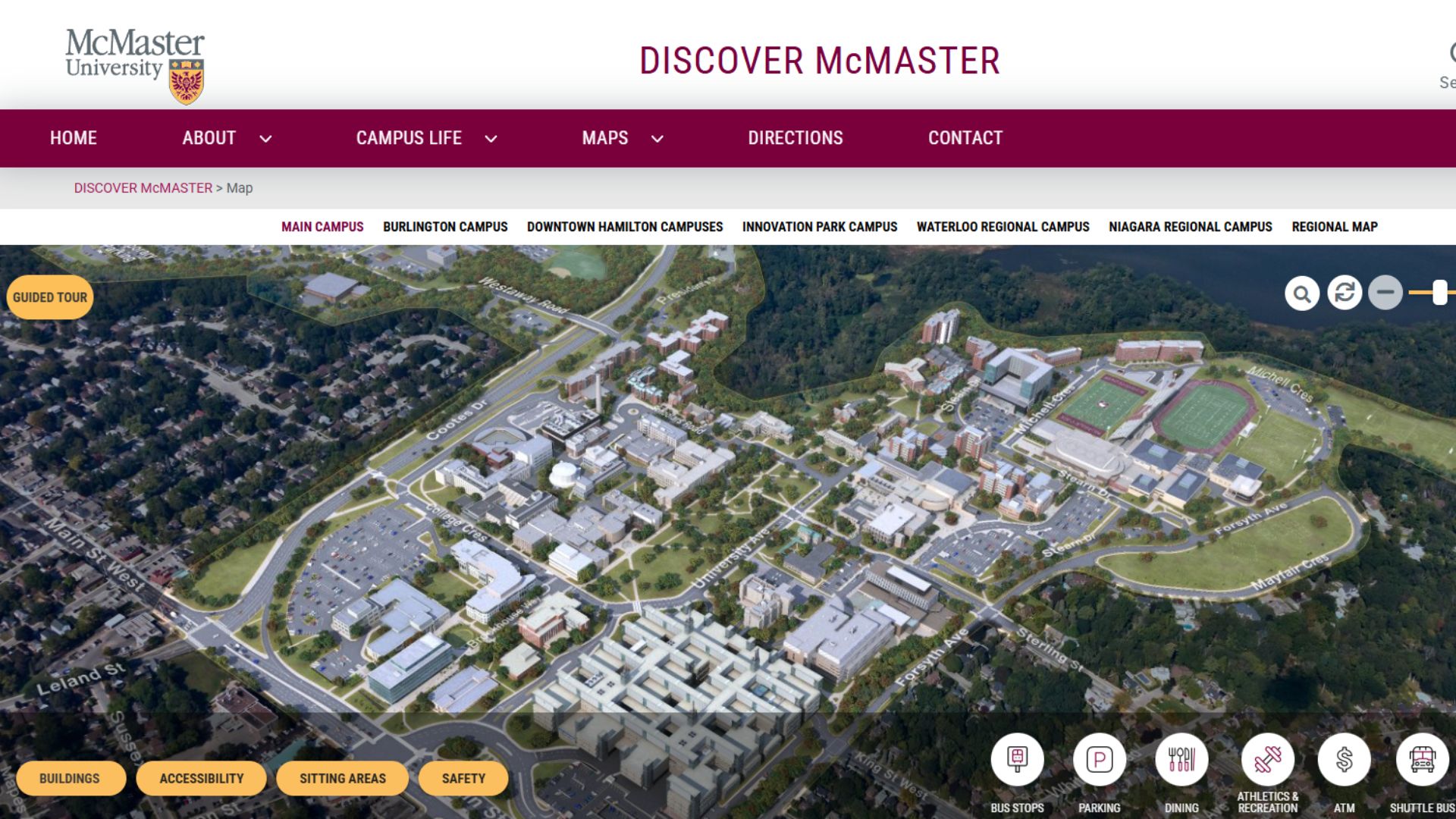Aerial view of McMaster University's campus, showcasing various buildings, parking areas, and green spaces. The layout includes nearby residential areas, roads, and pathways, with a focus on the main campus facilities. Navigation options are available at the bottom, highlighting features like accessibility, safety, and campus amenities.