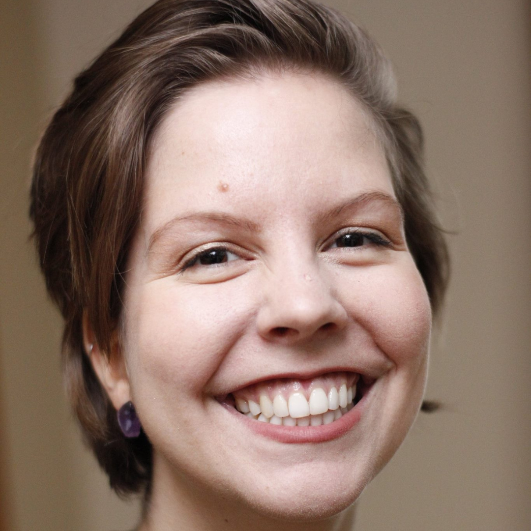 Close-up of a woman smiling, studio lighting